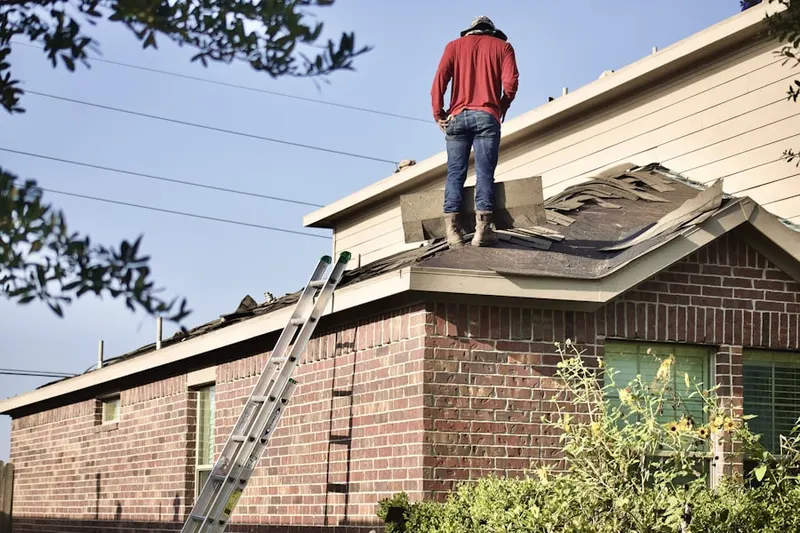 Professional roofer working on a residential roof in Pencoyd